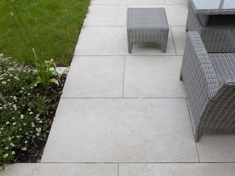 A patio with a table, chairs and umbrella
